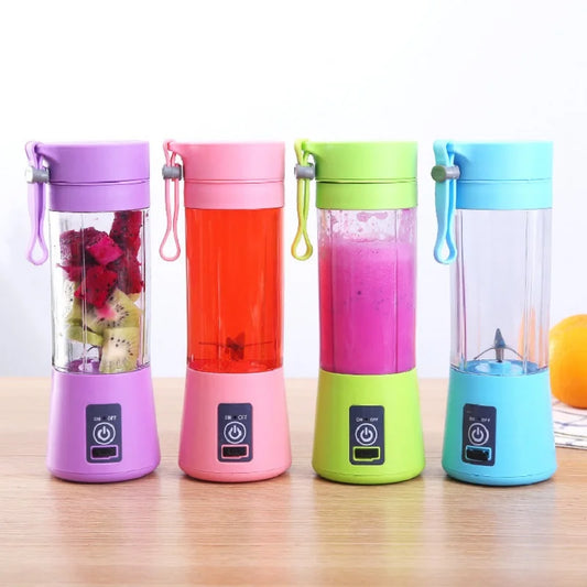 Four colorful portable blenders with fruit inside on a wooden surface.