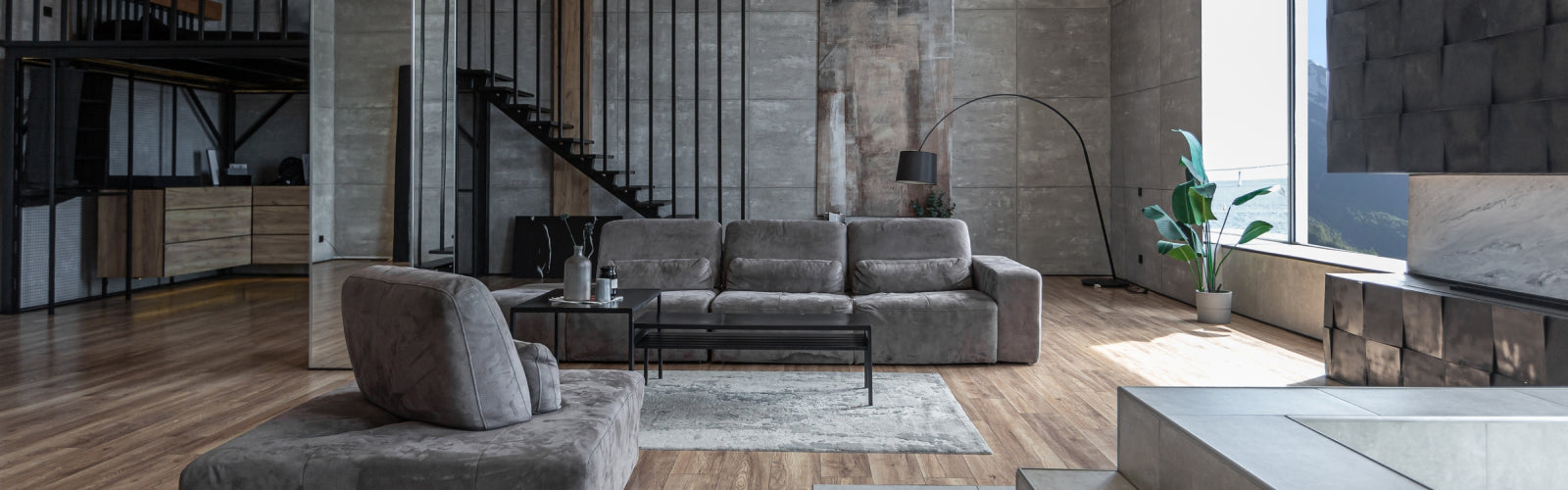 Modern living room with gray sofa, coffee table, and decorative elements.
