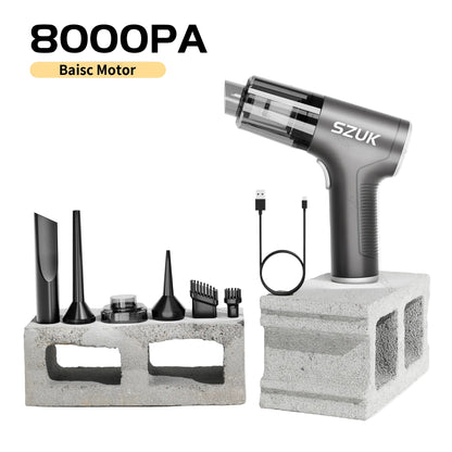 car mini vacuum cleaner with attachments on a concrete block against a light gray background